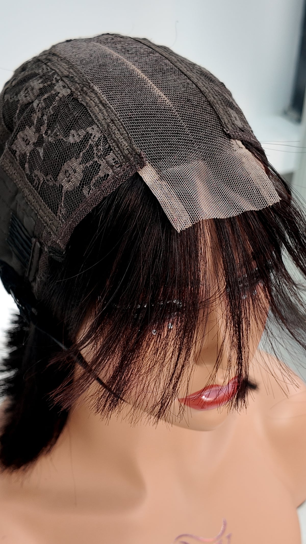 Close-up of UNices Hair chestnut brown bob with bangs 2x6 lace closure and wig cap construction
