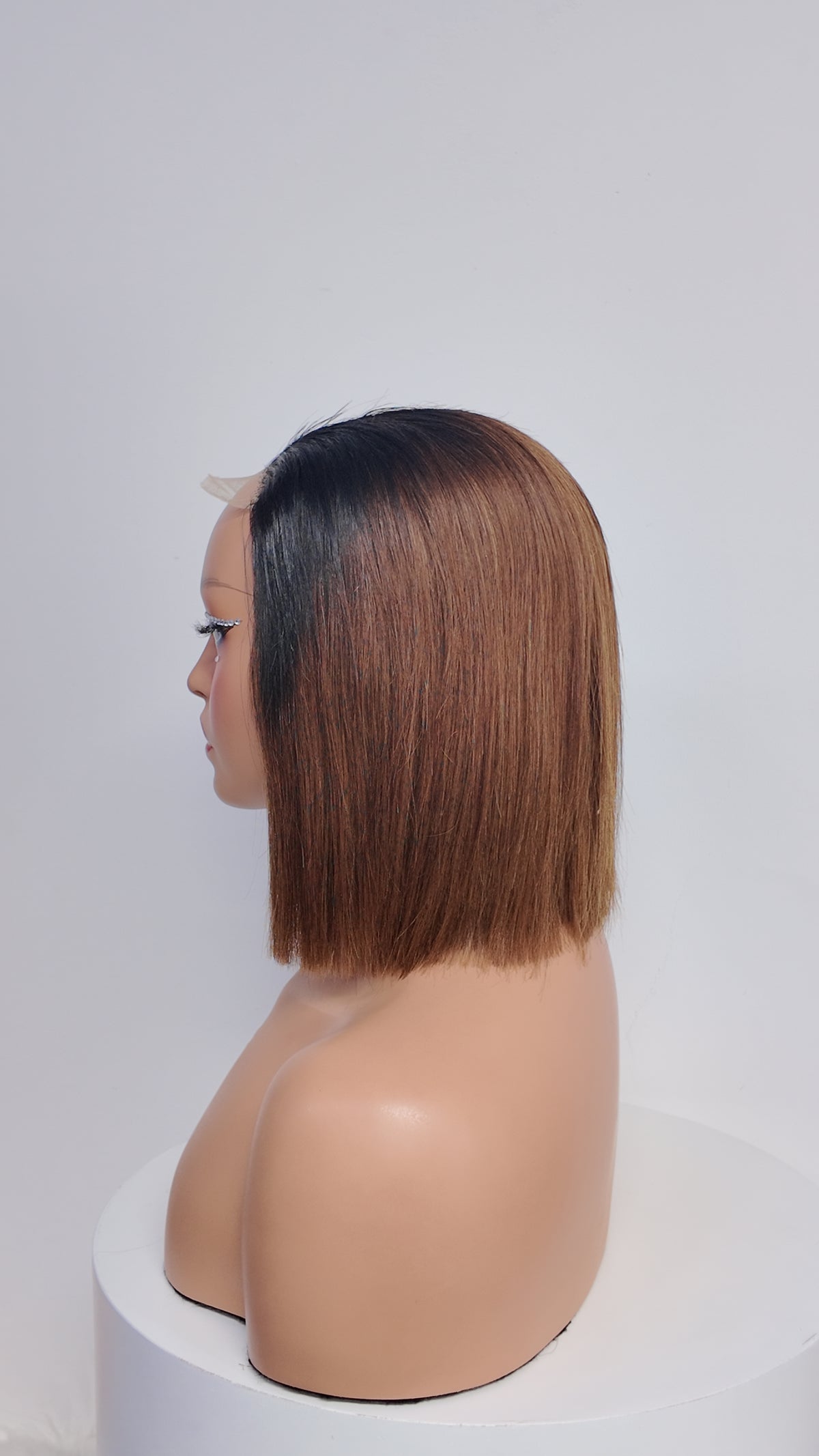 Side view of UNices Hair black root brown straight bob human hair wig