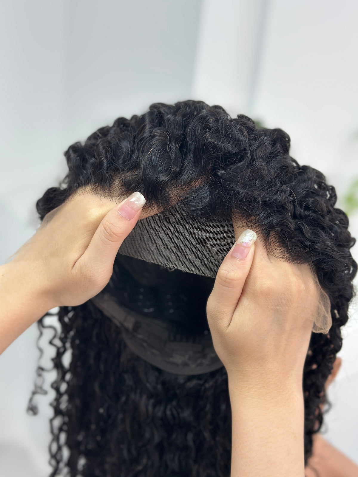 13x4 HD lace detail of UNices Hair 20 inch curly human hair wig in natural black