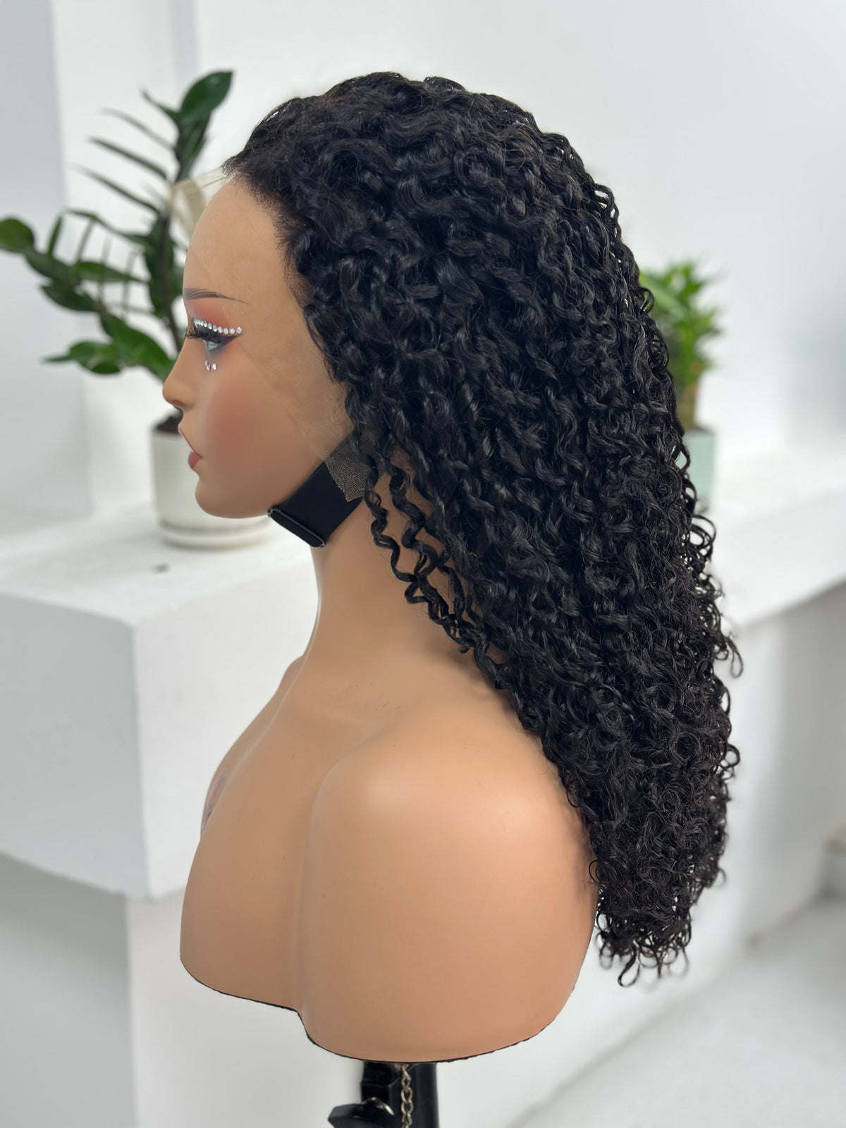 Side view of UNices Hair 20 inch curly human hair wig in natural black