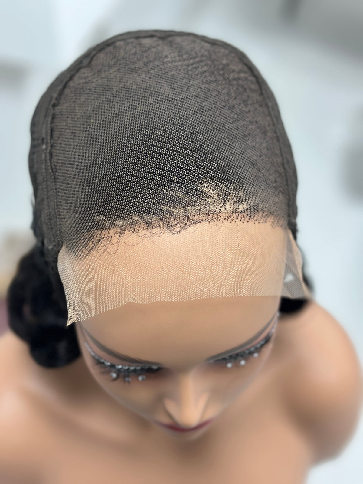Lace cap detail of UNices Hair 20 inch natural black retro curl wig