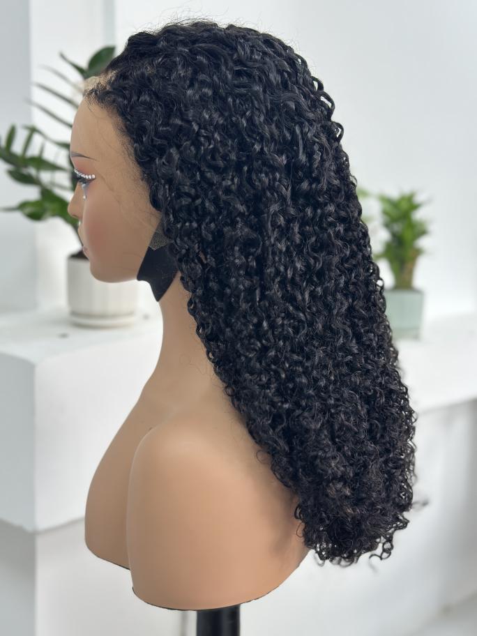 Side view of UNices Hair 22 inch curly human hair wig in natural black