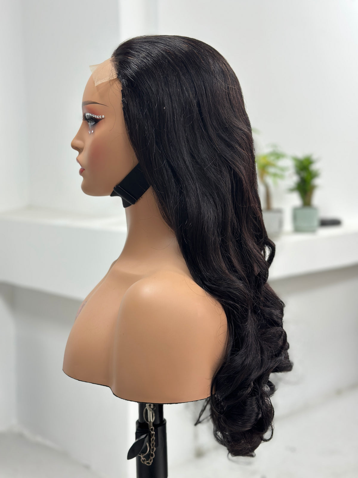 Side view of UNices Hair 26 inch natural black loose curl human hair wig