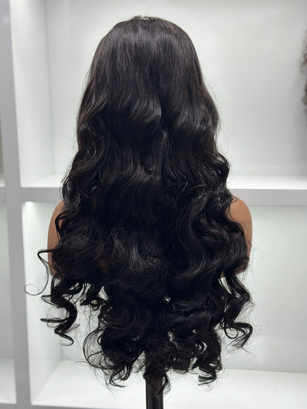 Back view of UNices Hair 28 inch natural black loose wave human hair wig