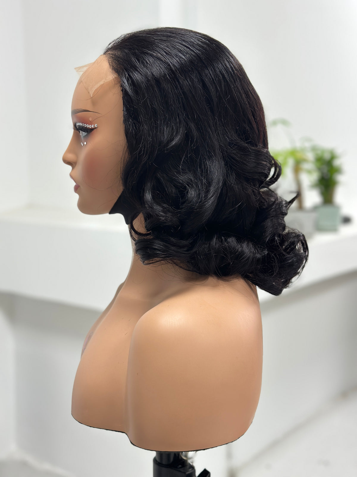 Side view of UNices Hair natural black retro curl 5x5 lace human hair wig